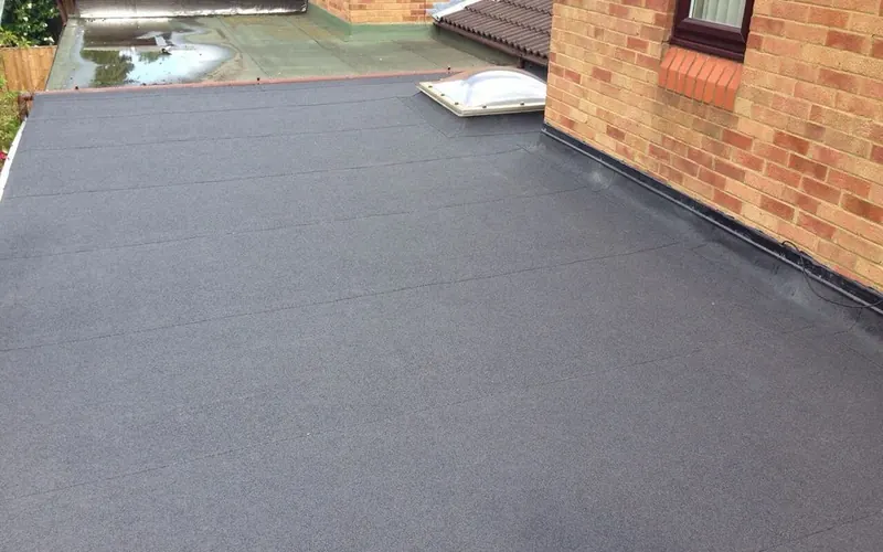 New grey membrane flat roof over a rear extension, completed by JFC Roofing and Building